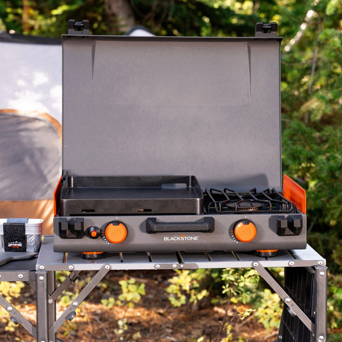 Blackstone 12x14" Camping Griddle and Side Burner For Outdoor Adventures

Pack your Griddle in the car and enjoy delicious meals wherever you end up. Built with a protective hood, latches, a handle, and a stow-and-go rear grease cup, this griddle packs up like a briefcase that is easy to carry with you. A 280 sq. in. Griddle and side burner with 14,400 combined BTUs make it easy to cook up your favorite griddle foods with the added versatility of being able to heat water, sauce or soups