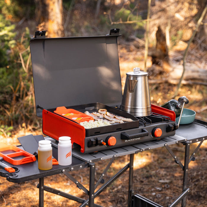 Blackstone 12x14" Camping Griddle and Side Burner For Outdoor Adventures

Pack your Griddle in the car and enjoy delicious meals wherever you end up. Built with a protective hood, latches, a handle, and a stow-and-go rear grease cup, this griddle packs up like a briefcase that is easy to carry with you. A 280 sq. in. Griddle and side burner with 14,400 combined BTUs make it easy to cook up your favorite griddle foods with the added versatility of being able to heat water, sauce or soups