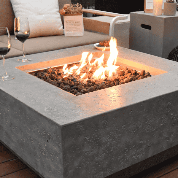 Elementi Manhattan High Performance Cast Concrete Fire Pit OFG103. Measuring at 36" in length, 36" wide, and 16" tall, it perfectly fits into your backyard oasis, adding a touch of sophistication. Crafted from durable, high-performance concrete, the Elementi Manhattan fire table ensures years of enjoyment. It comes with a 1-year warranty, providing peace of mind and guaranteeing its quality craftsmanship. Choose between the Natural Gas or Liquid Propane