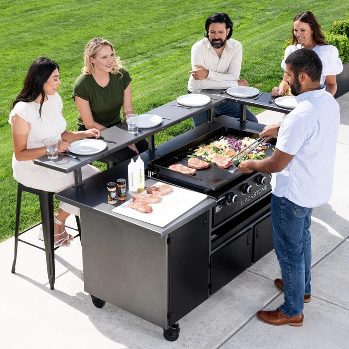 Introducing the Blackstone 5 Person Chefs Table with 36" Griddle - Model 6023. This culinary marvel is not just another outdoor grill; it's an experience waiting to be had. Designed for those who take their outdoor cooking seriously, this unit merges functionality with style, letting you cook and dine with friends and family in an engaging manner. Its expansive 36" griddle top allows for versatility in cooking, from breakfast spreads to evening BBQs.