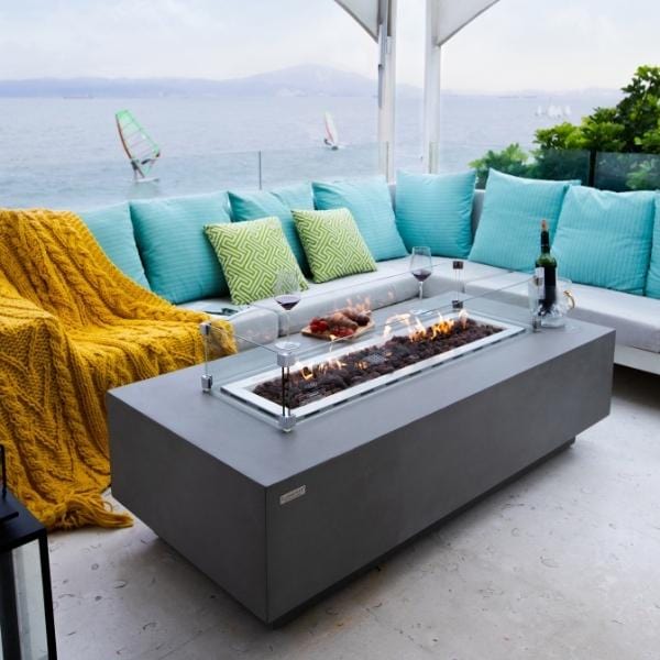 Elementi Granville Rectangular Concrete Outdoor Fire Pit Table OFG121. This magnificent rectangular fire table measures 60” by 27” by 17”. Its careful design includes a 30" long fire pit ring burner that can hold about 13.2 pounds of lava rocks. The entire fixture weighs 175 pounds, which ensures that it's stable enough to not tip over. The concrete fire table can produce dazzling dancing flames that dance about 18 to 26 inches high. The flames can raise the temperature to a maximum of 45,000 BTUs